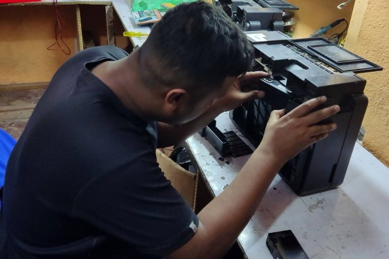 Our technician repairing a printer in the workshop